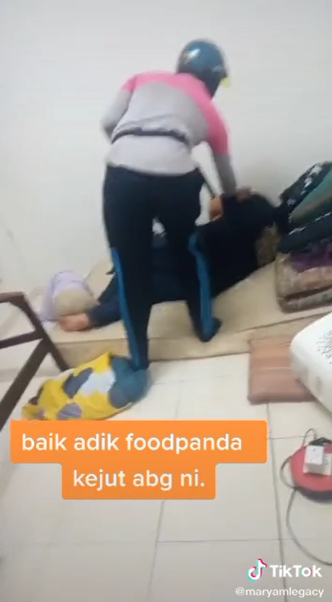 FoodPanda delivery rider tries to tap on his customer's shoulder.
