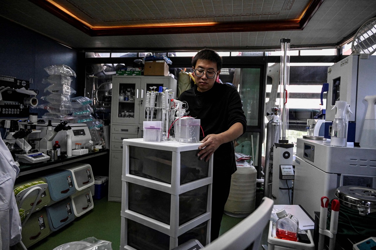 Mr Xu in his home lab making medicine for his son, who suffers from Menkes syndrome.