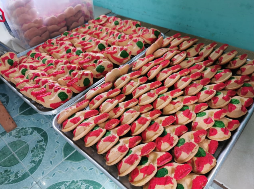 The Koi-shaped kuih bahulu laid out on baking trays.