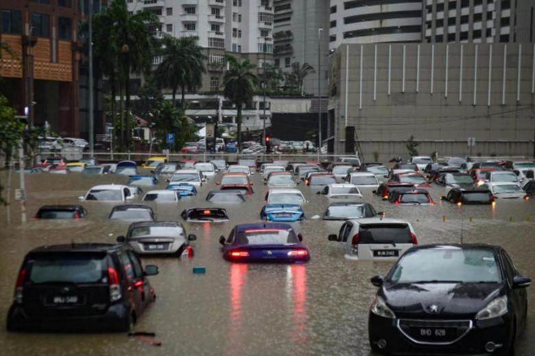 Cars in an open car park were left completely submerged by the floodwaters. Source: The Straits Times