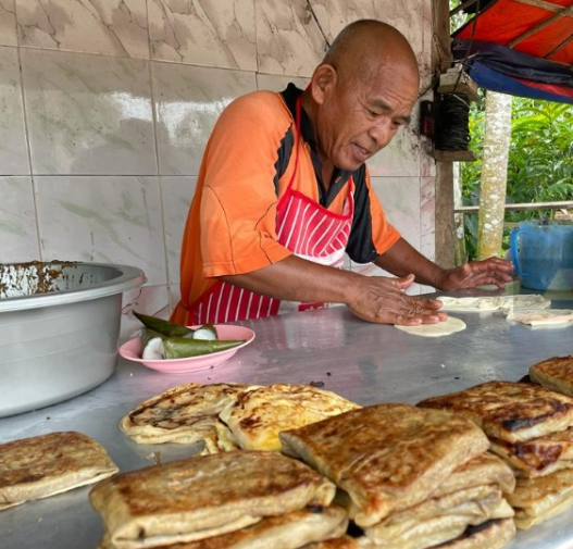 A Kelantan vendor strives to keep the prices of his roti canai at 50 sen a piece. Image credit: Sin Chew Daily