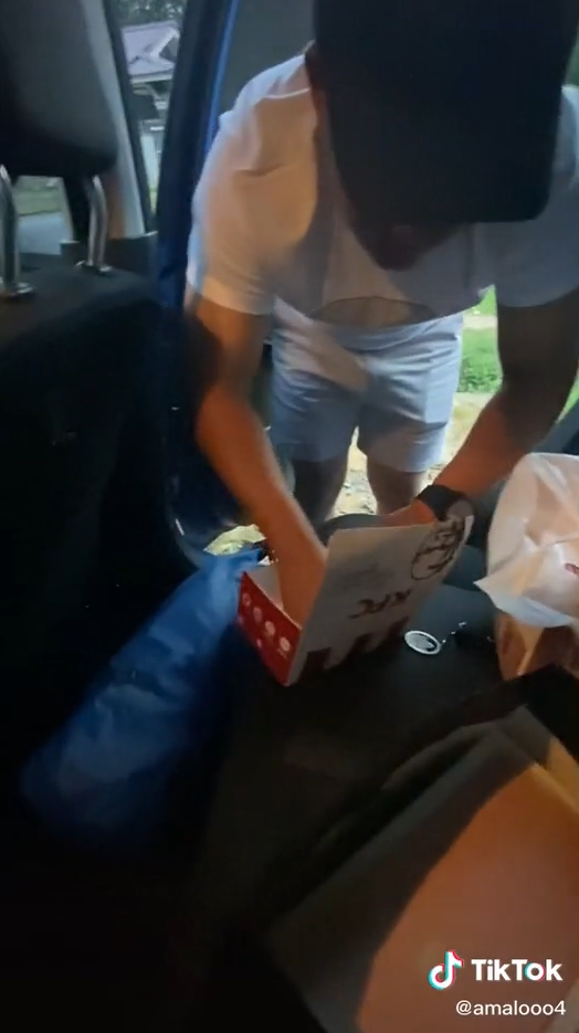 Akmal packing his gifts into KFC meal boxes.