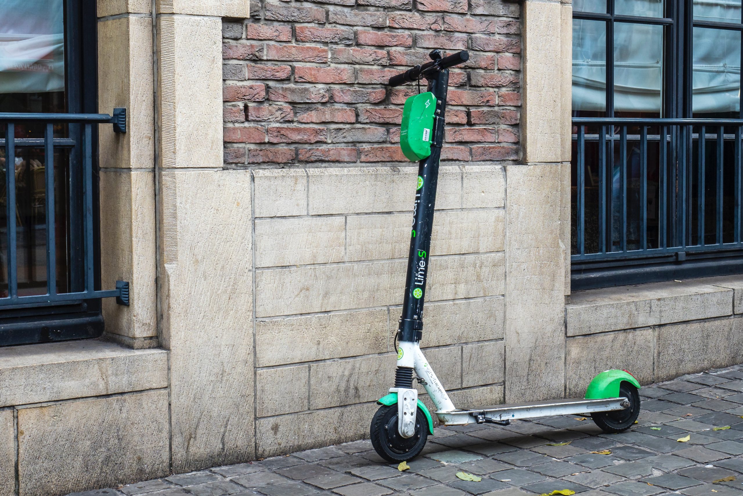 An e-scooter leaning by a wall.