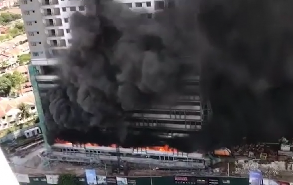 Smoke plumes from Taman Melati apartment on fire.