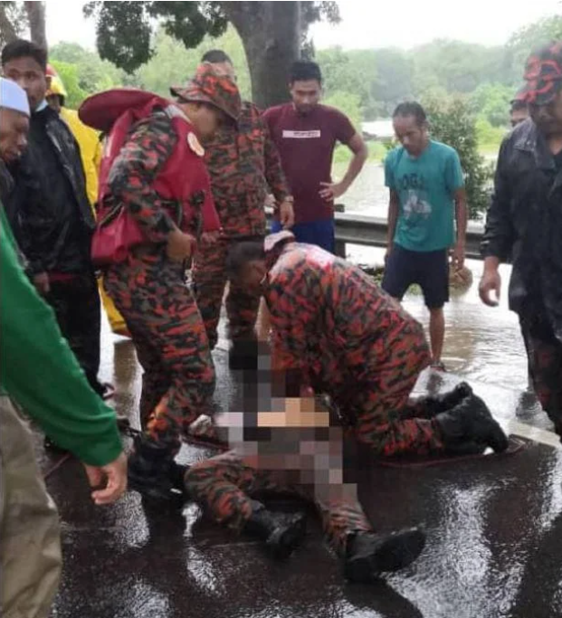 Firefighters attempting to resuscitate their colleague.