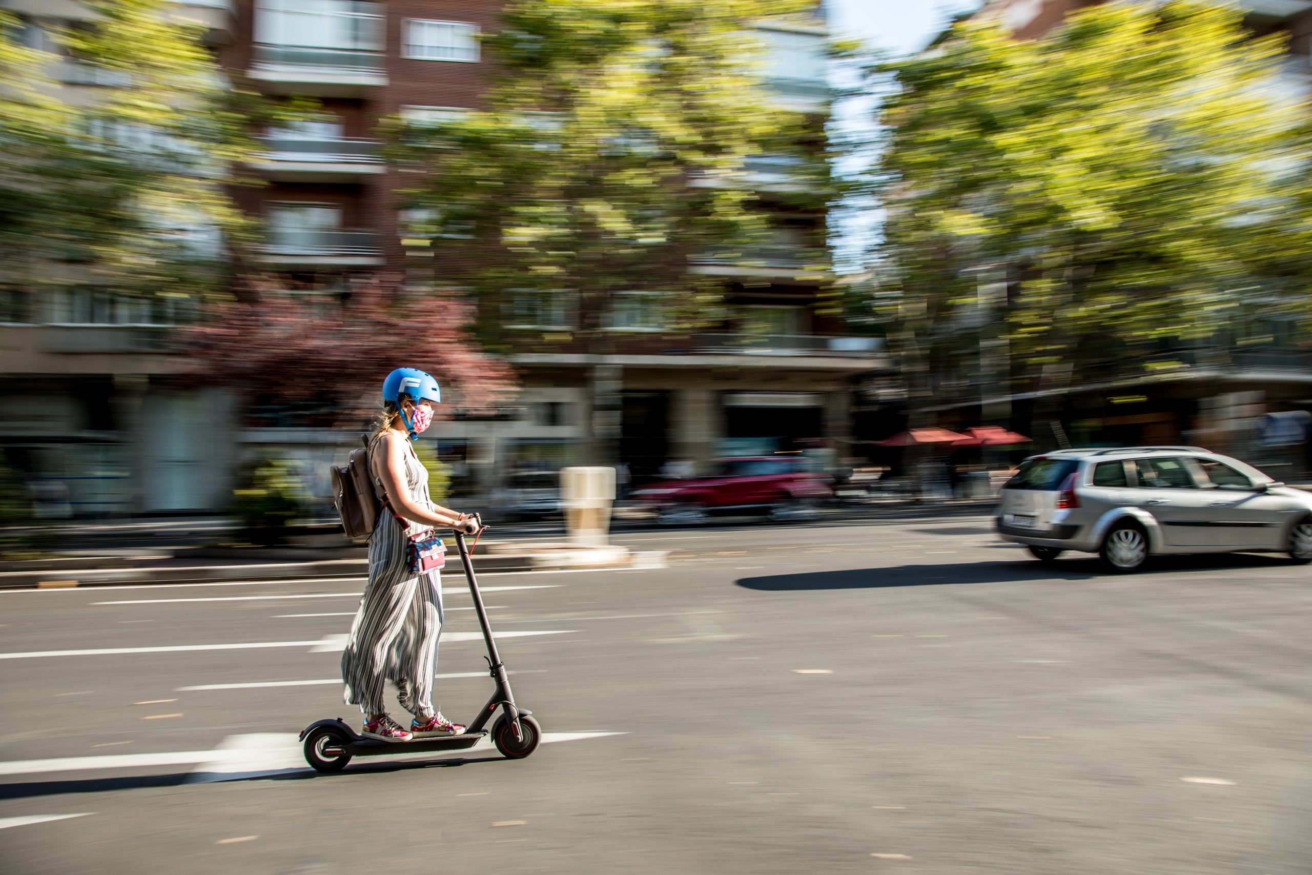 A woman riding an e-scooter.
