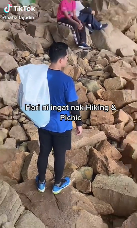 Hiker picking up trash from a mountain hike.