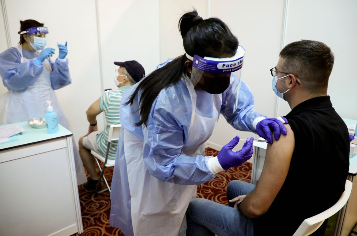 A Malaysian man receives his vaccination.