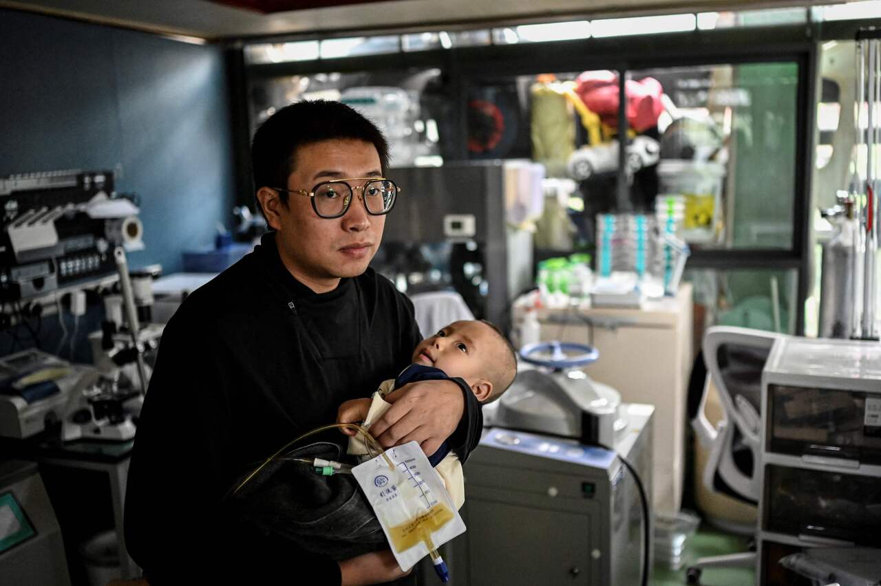 Mr Xu in his home lab making medicine for his son, who suffers from Menkes syndrome.