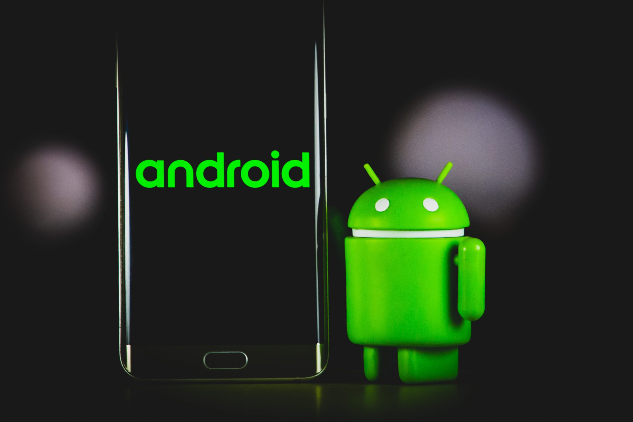The Android mascot next to an Android phone.