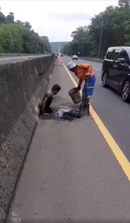 The young man pushing himself free from the drainage outlet.