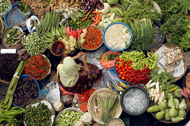 A woman selling vegetables in Malaysia.