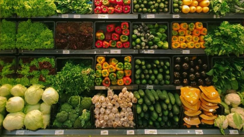 A supermarket display showing vegetables for sale.