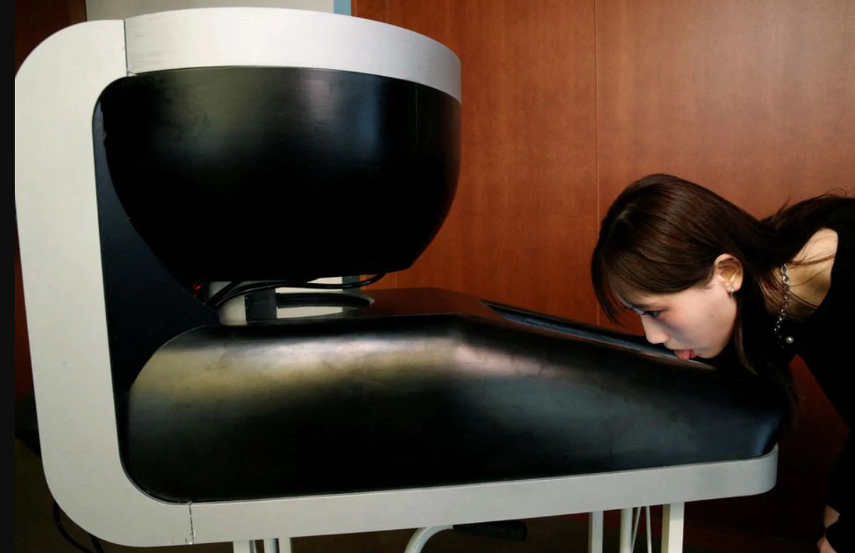 A student of the professor demonstrating how one can literally Taste-the-TV in action.