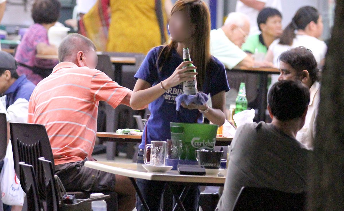 A man enjoying beer at a restaurant.