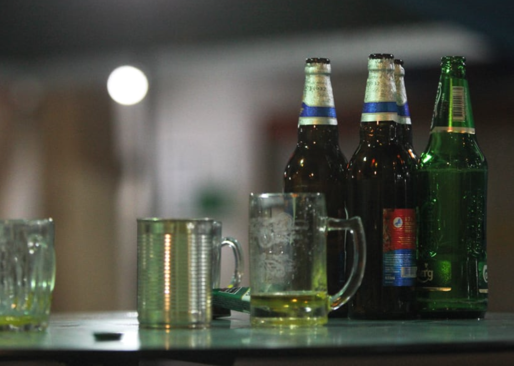 Discarded beer bottles at a kopitiam table.