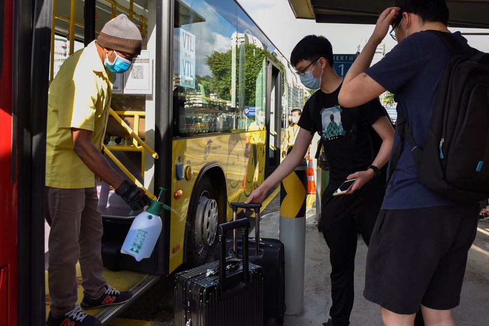 A VTL passenger having his luggage sanitised.