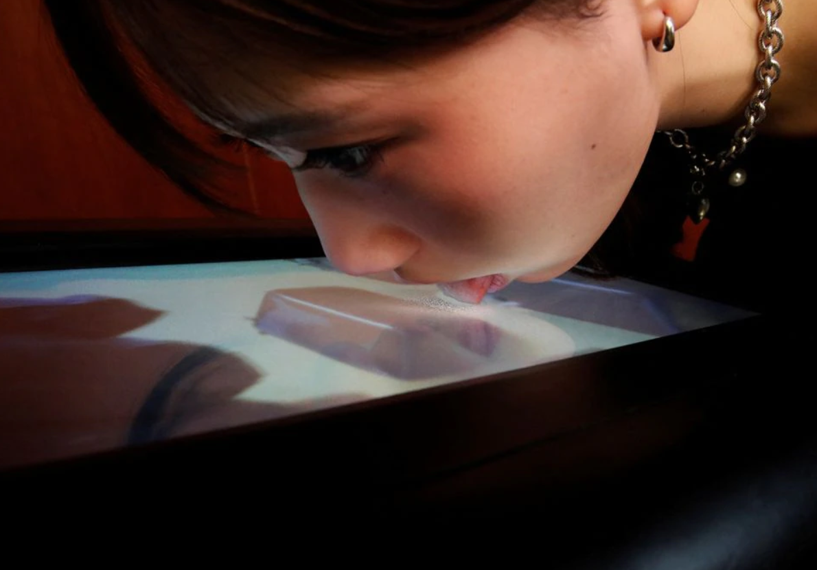 Professor Miyashita's student attempting to taste the screen.