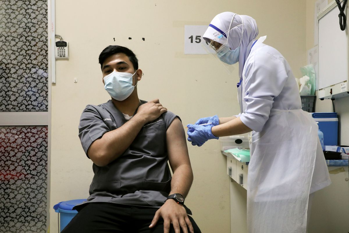 A Malaysian man receiving his vaccination. 