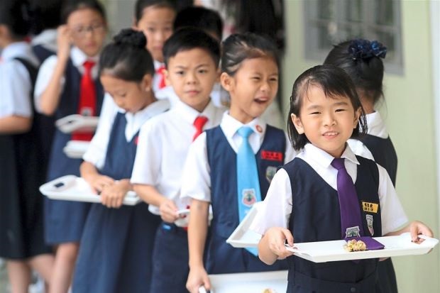 Chinese school students lining up for meals.