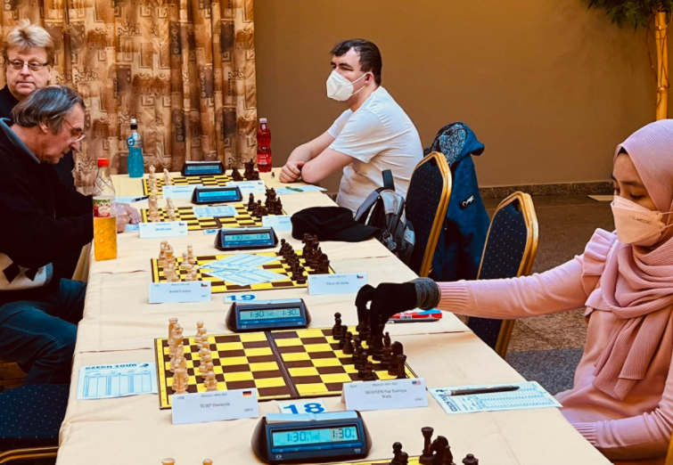 Nur Batrisya playing a game of chess at the international chess tournament.