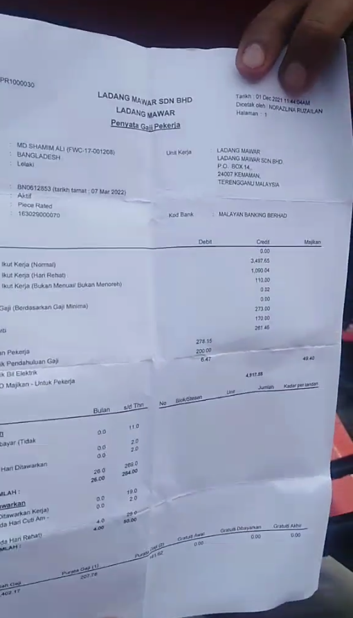 Mr Shamim showing his payslip dated December 2021.