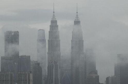 Clouds hang around the KLCC towers. 
