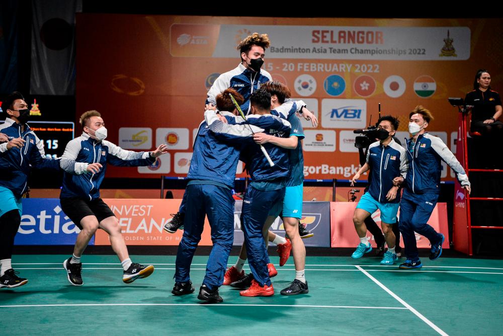 Team Malaysia celebrating their victory on the court after defeating Indonesia at the  2022 Badminton Asia Team Championships. 