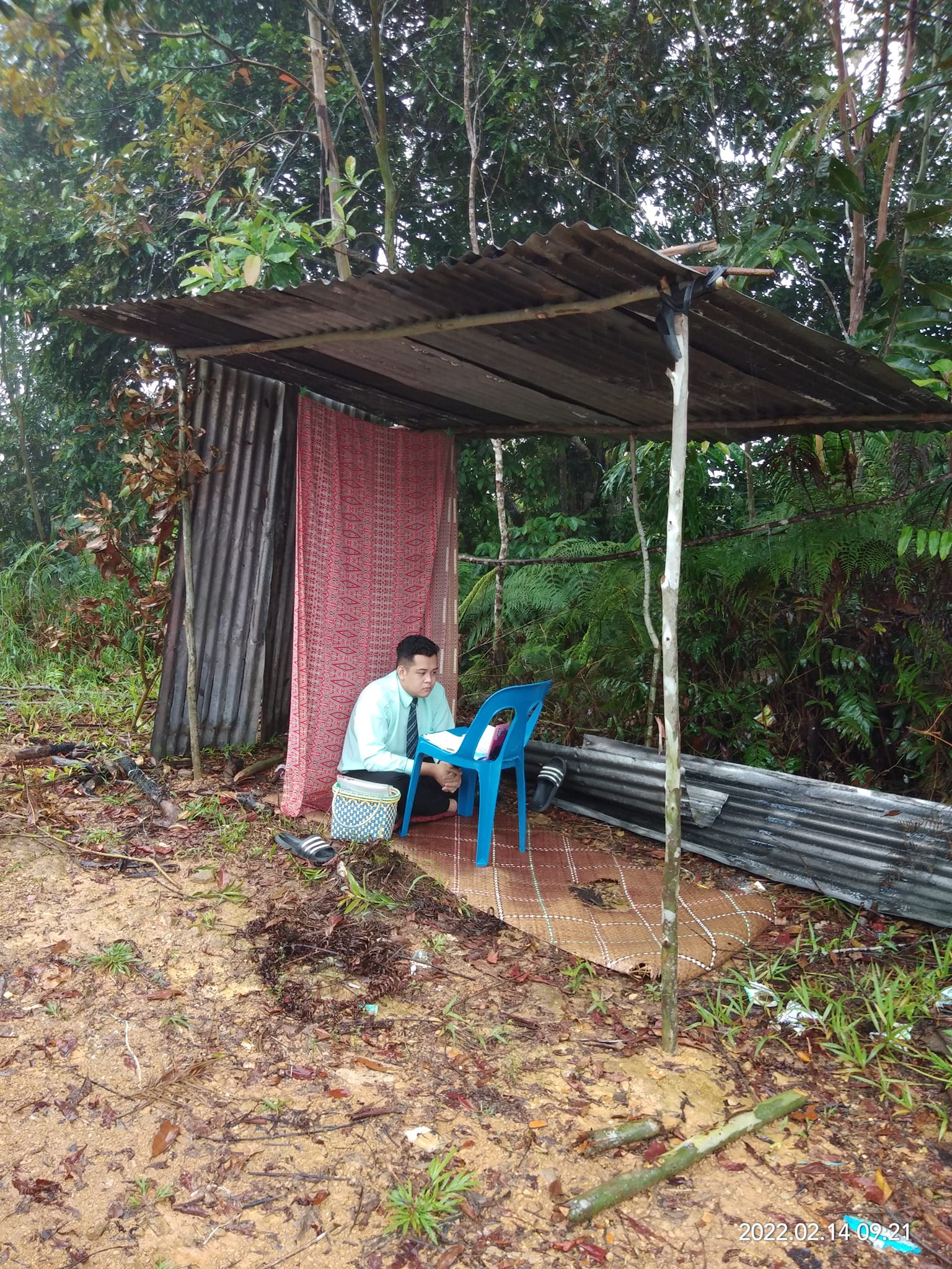 Frank conducting his interview in a makeshift hut up Bukit Kelingkang. 