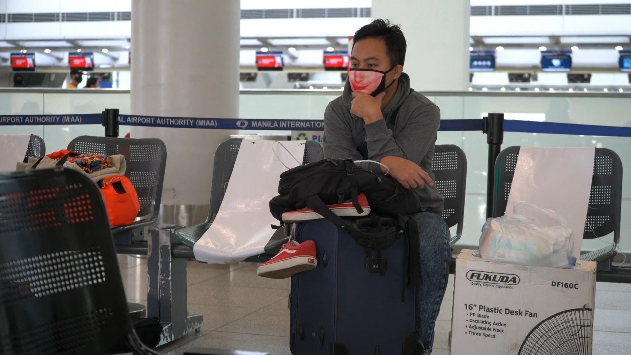 A traveller waits at an airport.