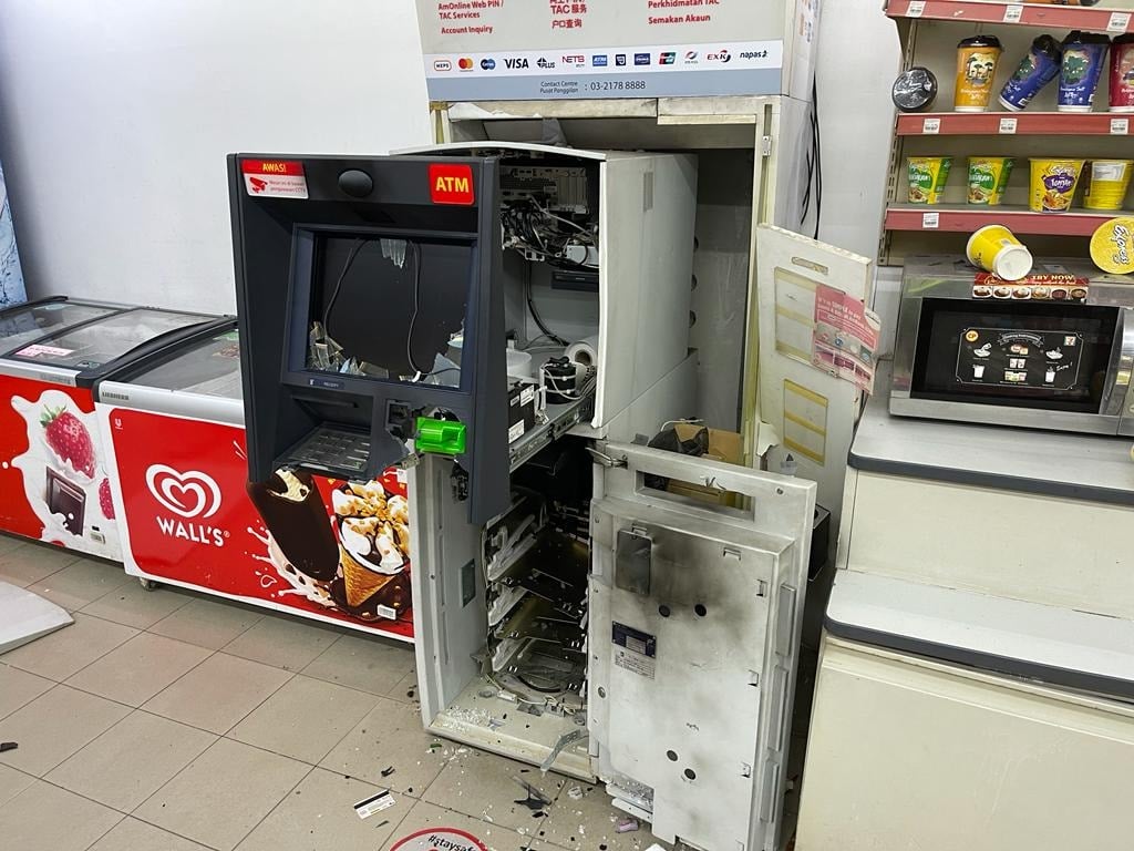 The aftermath of the ATM machine that was blown open at a Klang 7-Eleven.