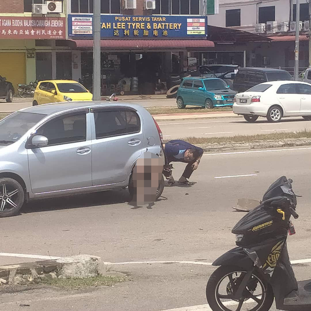 A motorcyclist died after being run-over and getting stuck in the wheel well of a Perodua Myvi. Image credit: FBT News