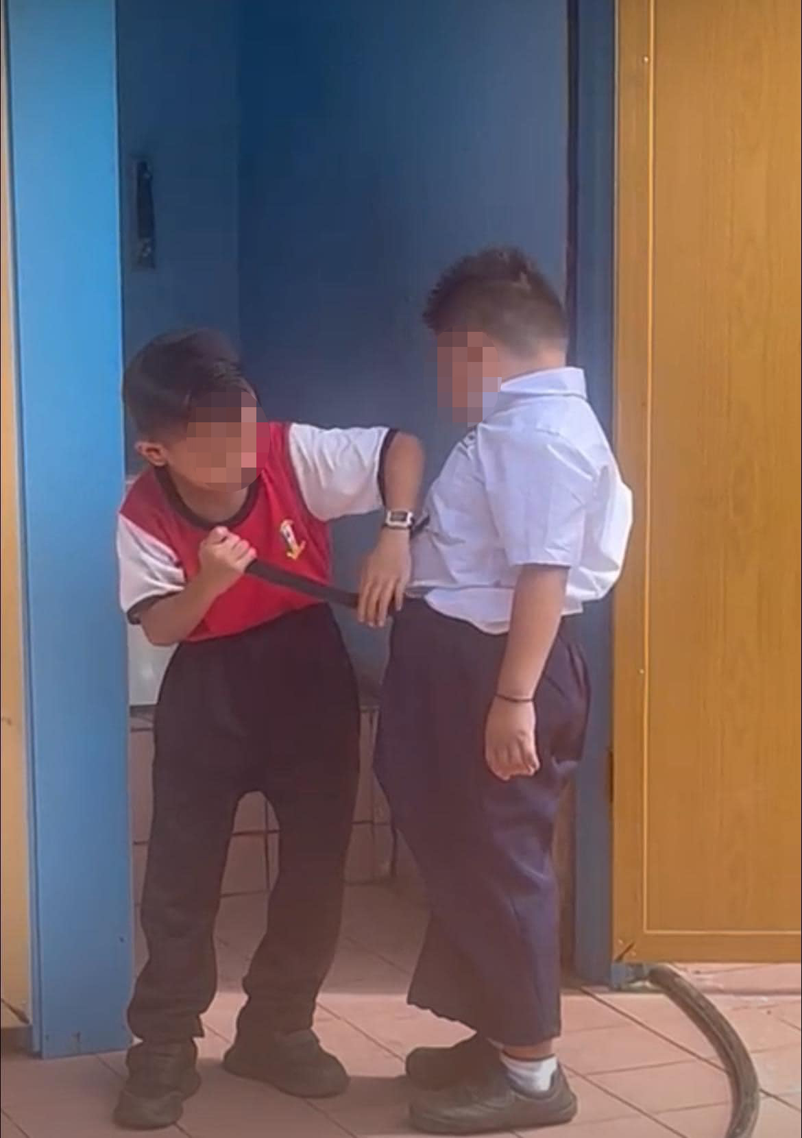 Two young boys were seen helping their friend with special needs to use the toilet. Image credit: Sylvester Ronny Pulene