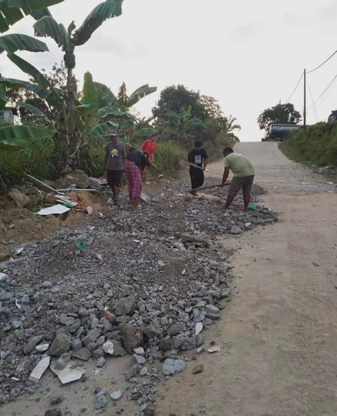 Residents of a Sandakan village have taken to fixing potholes along a local road themselves. Image credit: ISU Sandakan