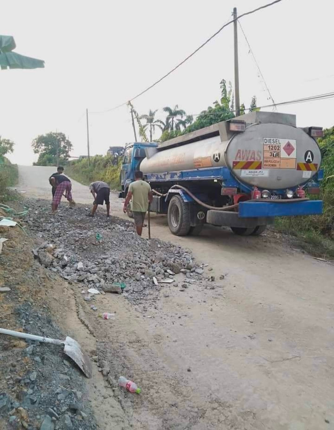 Residents of a Sandakan village have taken to fixing potholes along a local road themselves. Image credit: ISU Sandakan