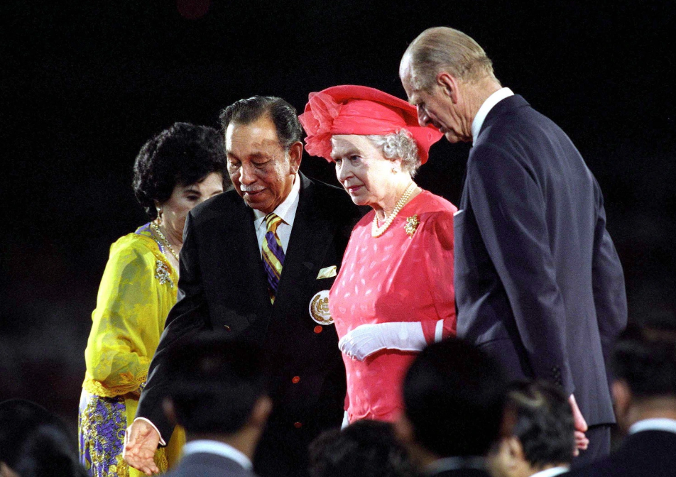 Her Majesty and Prince Philip photographed attending the 16th Commonwealth Games in Kuala Lumpur. Image credit: Showbiz Cheat Sheet