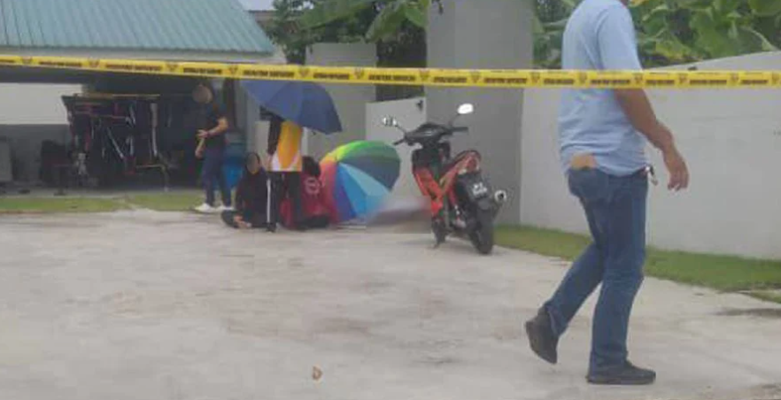The compound of the family's home was sealed off in the wake of the incident. Image credit: NST