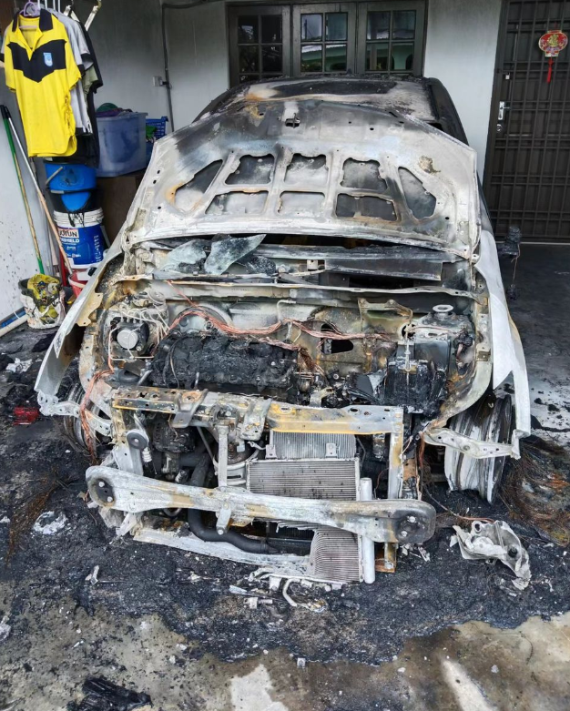 Their car was petrol bombed, causing it to be severely destroyed. Image credit: China Press